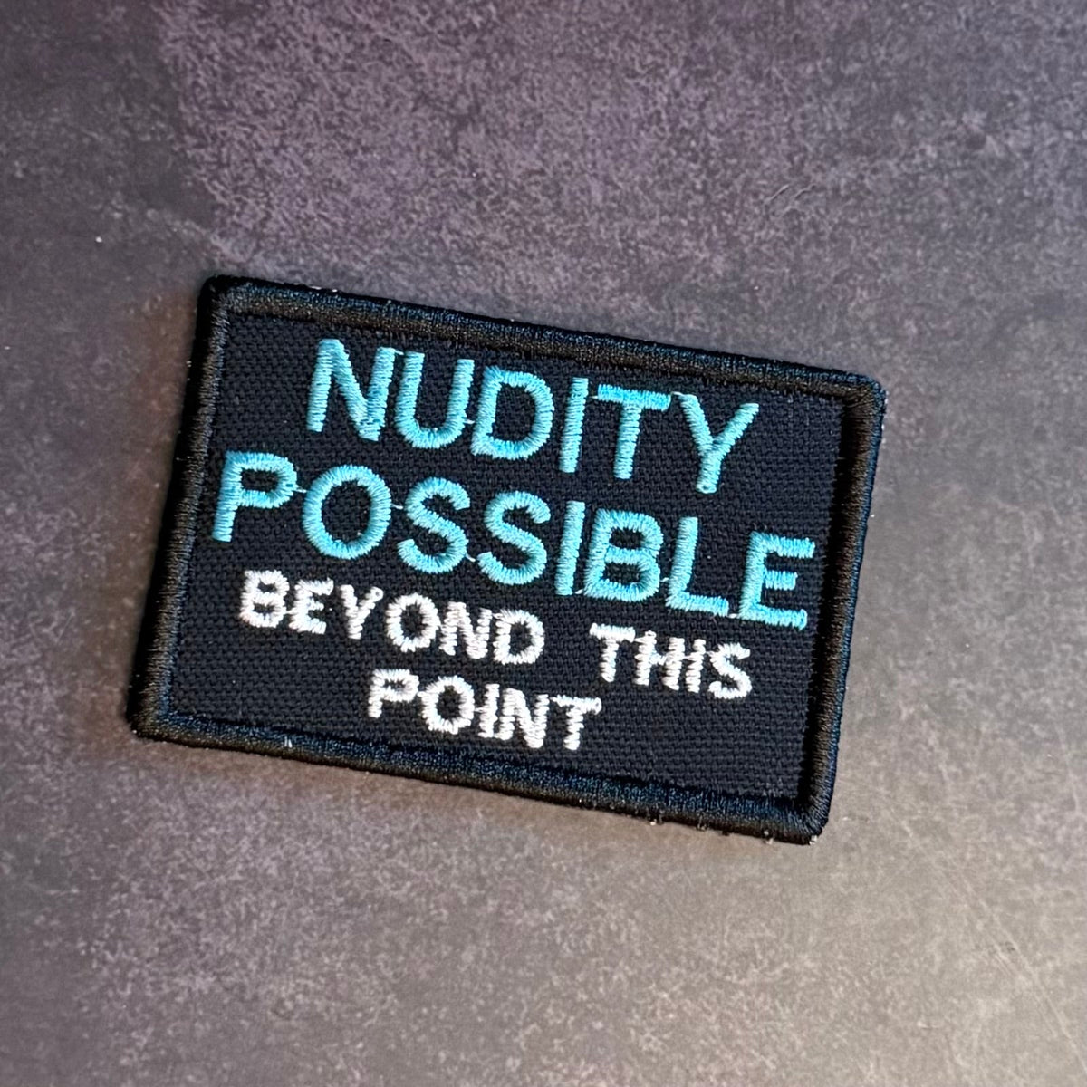 Nudity Possible Beyond This Point Funny Embroidered Morale Patch, 2x3" | VELCRO® Brand Hook Backing
