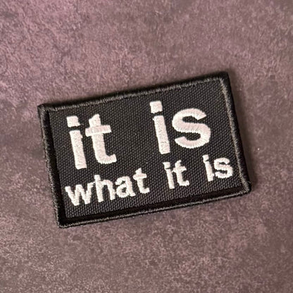 It Is What It Is Funny Morale Patch, 2x3" | Made in USA | VELCRO® Brand Hook Backing