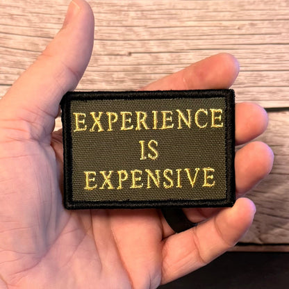 Experience Is Expensive Funny Tactical Morale Patch, 2x3" | Made in USA | VELCRO® Brand Hook Backing