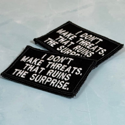 I Don't Make Threats, That Ruins The Surprise Funny Morale Patch, 2x3" | Made in USA | VELCRO® Brand Hook Backing