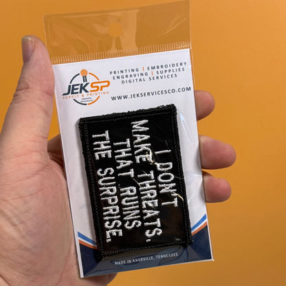 I Don't Make Threats, That Ruins The Surprise Funny Morale Patch, 2x3" | Made in USA | VELCRO® Brand Hook Backing