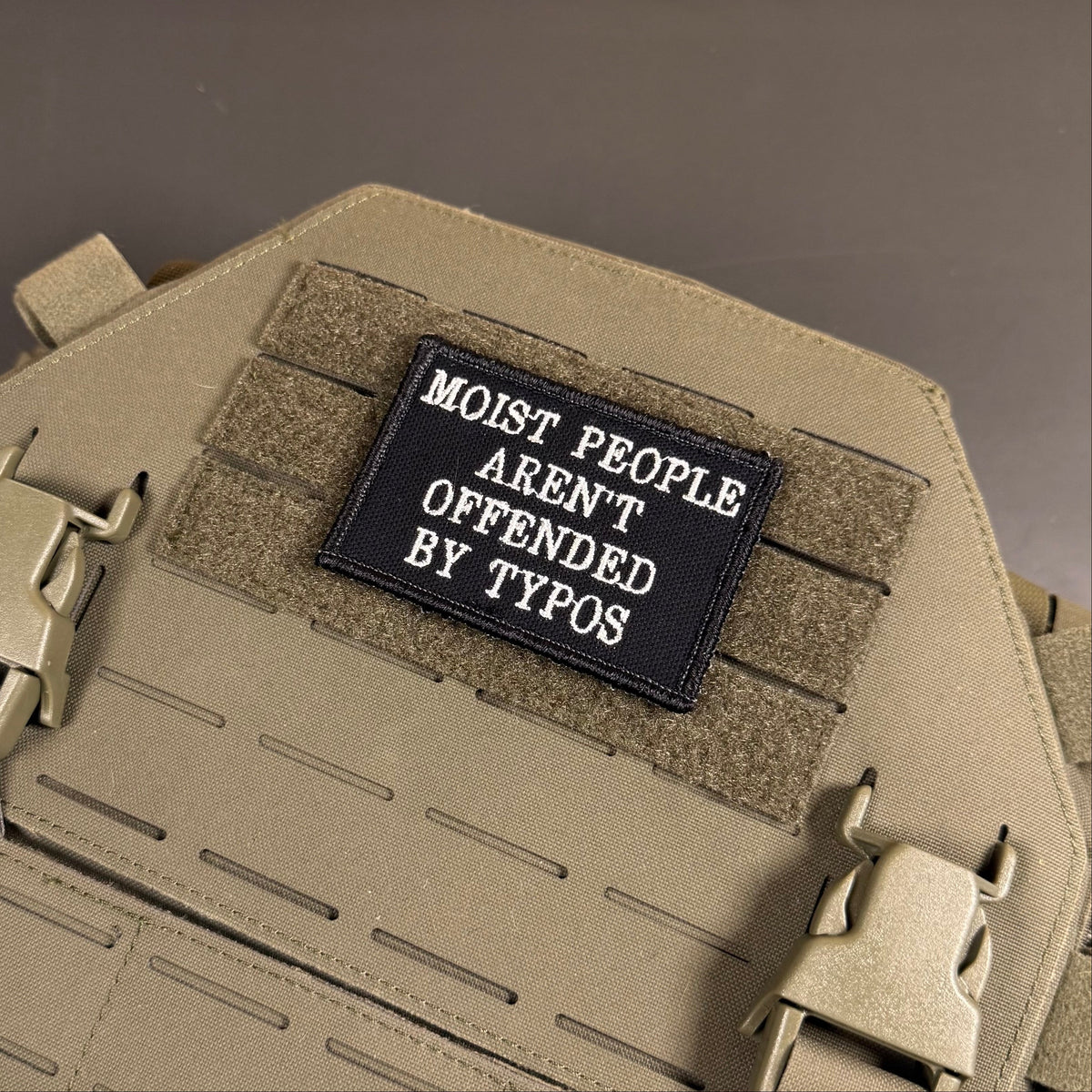 Moist People Aren’t Offended by Typos Funny Morale Patch, 2x3" | Made in USA | VELCRO® Brand Hook Backing