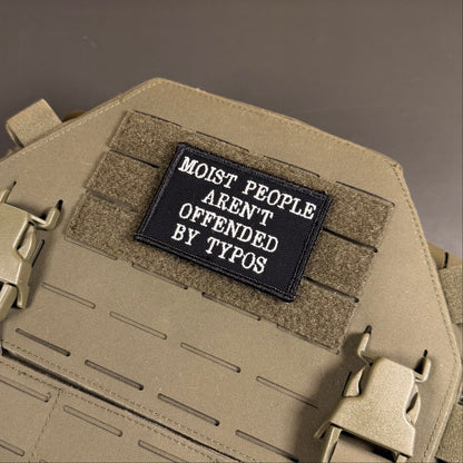 Moist People Aren’t Offended by Typos Funny Morale Patch, 2x3" | Made in USA | VELCRO® Brand Hook Backing