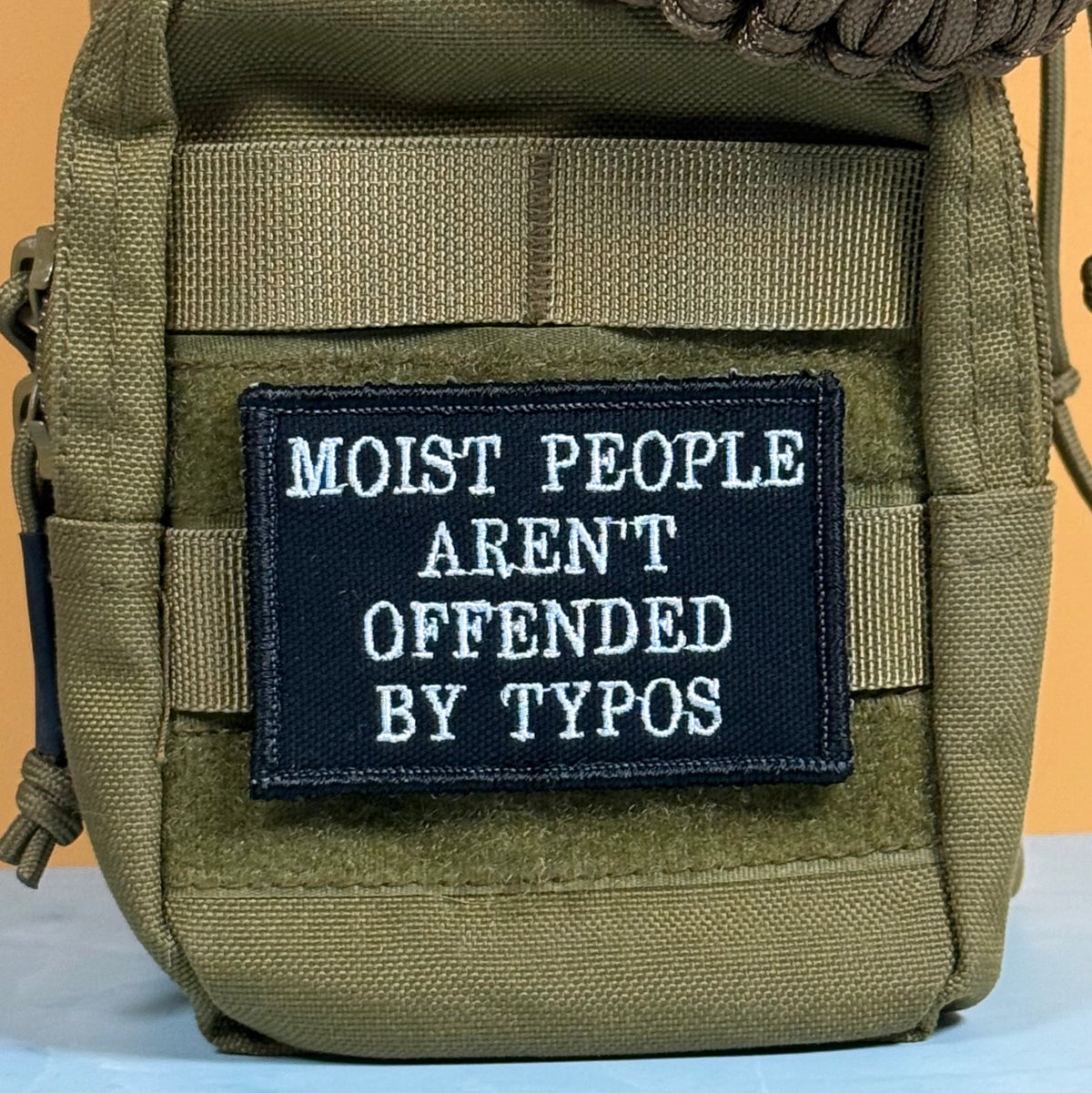 Moist People Aren’t Offended by Typos Funny Morale Patch, 2x3" | Made in USA | VELCRO® Brand Hook Backing