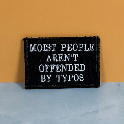 Moist People Aren’t Offended by Typos Funny Morale Patch, 2x3" | Made in USA | VELCRO® Brand Hook Backing