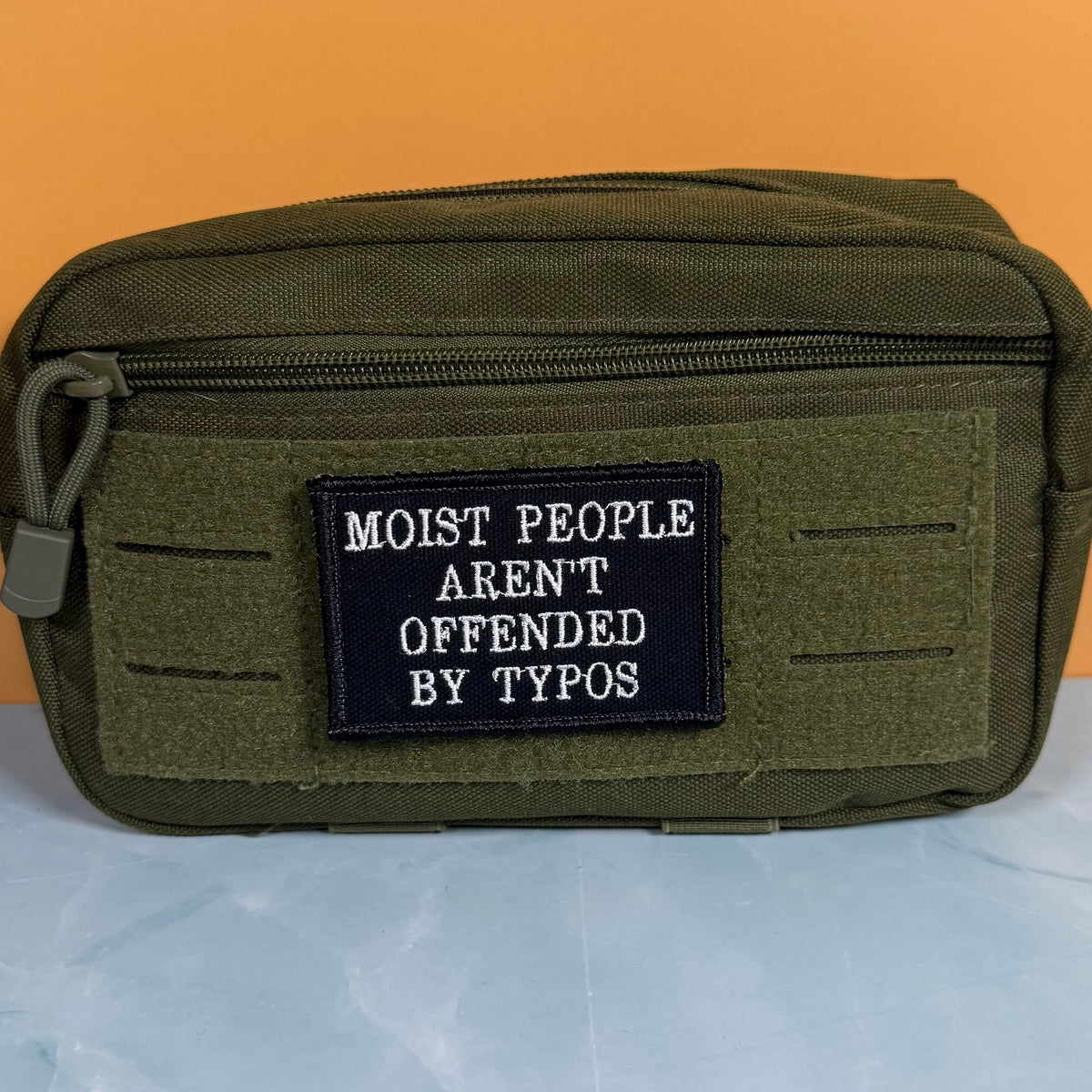 Moist People Aren’t Offended by Typos Funny Morale Patch, 2x3" | Made in USA | VELCRO® Brand Hook Backing